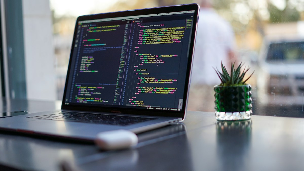 Masada açık dizüstü bilgisayarda kod editörü (Laptop with code editor)