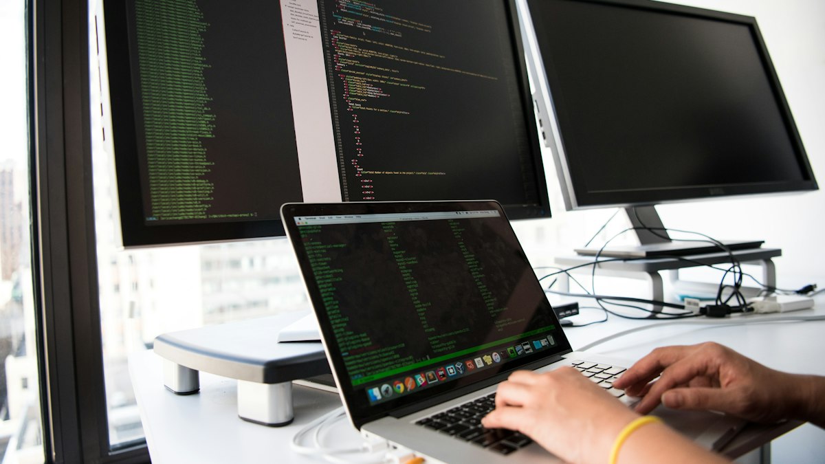 Dizüstü bilgisayarda kod yazan geliştirici (Developer writing code on a laptop)